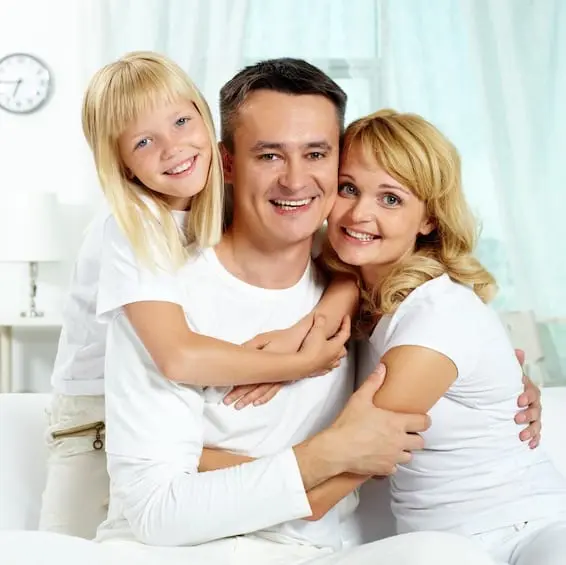 A family of four smiling together