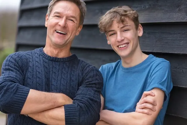 A father and his young son smiling