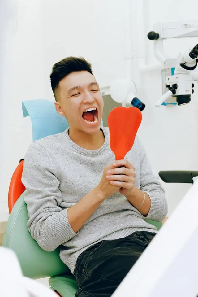 A dental hygienist cleaning a patient's teeth