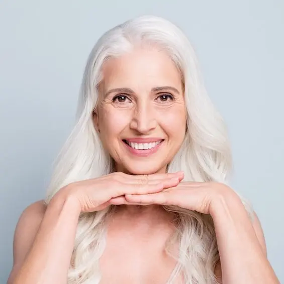 A woman smiling after cosmetic dental treatment